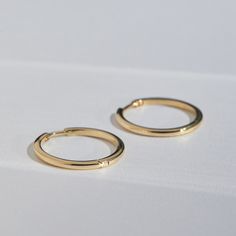 Simple, classic, well-made everyday hoops. Adds some polish and shine, with a nice clean line. Classic Hoop Earrings As Gift, Classic Round Hoop Earrings For Everyday, Classic Round Huggie Earrings With Shiny Finish, Classic Round Huggie Earrings, Classic Huggie Earrings As Gift, Classic Polished Huggie Earrings For Formal Occasions, Classic Huggie Earrings, Classic 14k Gold Huggie Earrings, Formal Classic Huggie Earrings With Polished Finish