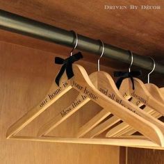 four wooden hangers with black bows on them