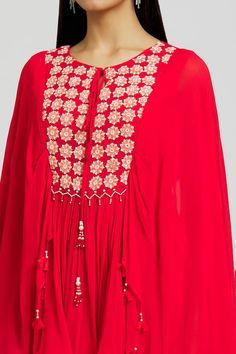 Red georgette kaftan with beads and mirror embroidered circles. Comes with gharara.
Components: 2
Pattern: Embroidered
Type Of Work: Beads, Mirror
Neckline: Round
Sleeve Type: Flared Sleeves
Fabric: Georgette
Color: Red
Other Details: 
Attached lining
Length:
Kaftan: 29 inches
Gharara: 43 inches
Closure:
Kaftan - Front tie-up
Gharara: Side zip
Occasion: Sangeet - Aza Fashions Mirror Work Kaftan, Round Mirror Work, Embroidered Circles, Georgette Kaftan, Kaftan Pattern, Embroidered Beads, Types Of Work, Beaded Neckline, Round Mirror