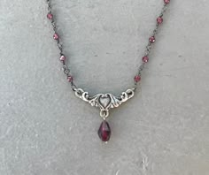 This dainty necklace is handmade using a 2mm genuine garnet rosary chain and a 18mm x 9mm heart connector with a 5mm garnet drop charm. A gold version is also available in my shop. This necklace is hypoallergenic. (Cadium free, lead free, and nickel safe) Garnet is an energizing stone that promotes passion and love.  The necklace comes in a ribbon-wrapped box, ready to be gifted. If you would like to leave a note for the recipient, you can do so during checkout. Garnet Rosary, Necklace With Charms, Jewelry Fancy, Etsy Jewellery, Edgy Jewelry, Rosary Necklace, Crystal Necklaces, Garnet Necklace, Nail Jewelry