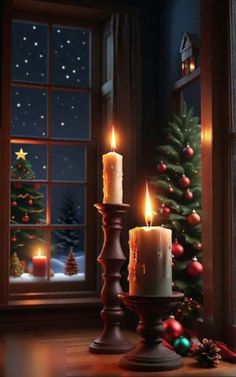 two lit candles sitting on top of a table next to a christmas tree in front of a window