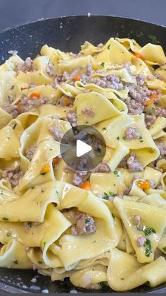 a skillet filled with pasta and meat