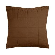 a brown pillow on a white background