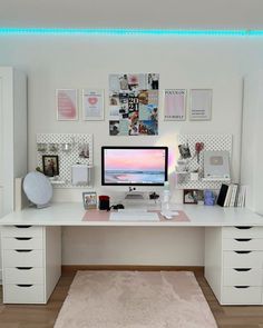 a white desk topped with a computer monitor