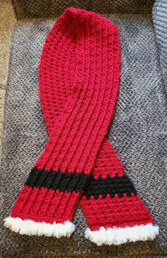 "Santa scarf. Festive, warm, fun & stylish.  Length: 58\" - 148 cm Width: 6\" - 15 cm Machine washable acrylic yarn. Matches listings in this shop for fingerless gloves, boot toppers, ponytail & pompom hats. Contact shop owner for custom orders & sizes." Santa Scarf, Knights Helmet, Boot Toppers, Messy Bun Hat, Bun Hat, Shop Owner, Pom Pom Hat, Fingerless Gloves, Acrylic Yarn