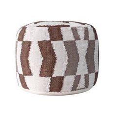 a brown and white poufce sitting on top of a table