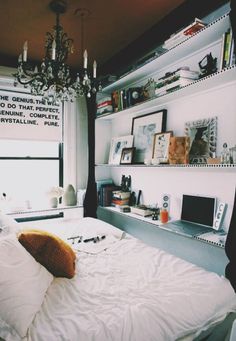 a bed sitting under a window in a bedroom