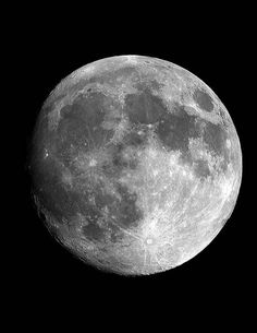 the full moon is shown in black and white