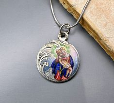 A magnificent antique silver enamel Pieta medal, petite Austrian enamel amulet on a 16 inch long sterling chain, rare Virgin Mary Catholic charm, very nicely done, in good condition, ideal for strength and protection necklace, would make a nice gift for someone special! Comes with approx. 16 inch long 925 silver necklace (see photo 5)! Material: solid silver, enamel Total weight: 6.6g Measures: approx. 22 mm (0.8 inch) in diameter PLEASE LOOK AT THE PICTURES, THEY ARE PART OF THE DESCRIPTION AND ARE THE ACTUAL ITEM YOU WILL RECEIVE. ALL OUR ITEMS ARE IN WORN, VINTAGE CONDITION. Oval Engraved Enamel Necklace, Enamel Medallion Necklace With Hallmark, Vintage Nickel-free Enamel Necklaces, Enamel Pendant Necklaces With Vintage Charm, Silver Enamel Jewelry With Vintage Charm, Silver Enamel Necklace With Soldered Details, Silver Enamel Necklaces With Soldered Details, Antique Silver Enamel Necklace, Victorian Silver Enamel Jewelry