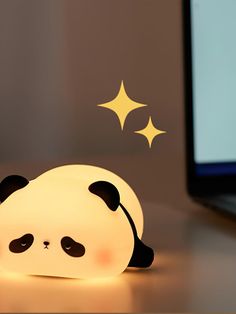 a panda bear lamp sitting on top of a desk