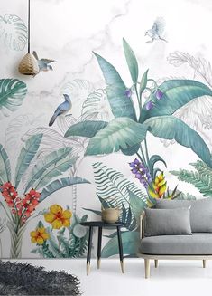 a living room with tropical wallpaper and grey couch in front of the painting on the wall