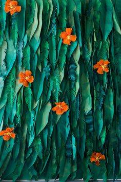 an abstract painting with orange flowers on green leaves