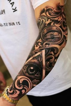 a man's arm with an eye and clock tattoo on it