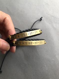 two black and gold bracelets that say no 22 - 23 with the words vn02 - 22 on them