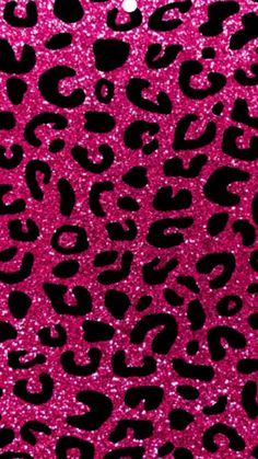 a pink and black leopard print wallpaper with lots of glitter on the bottom half of it