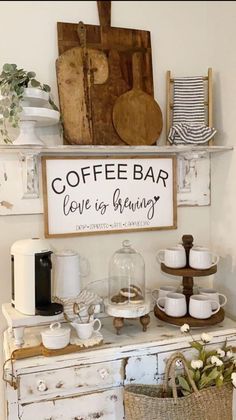 a coffee bar with cups and saucers on the top, next to a sign that says coffee bar love is growing