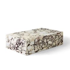 a white and brown marble box sitting on top of a table