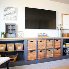 a living room filled with furniture and a flat screen tv mounted to the side of a wall