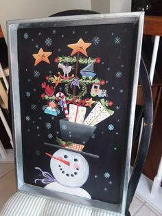 a chalk board with a snowman and christmas decorations on it