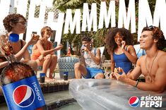 a group of people sitting next to each other in front of a sign that says pepsi