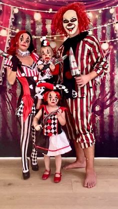 two adults and one child dressed up as clowns with their faces painted red, white and black