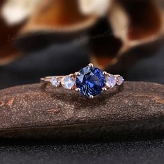 Art Deco Round Sapphire Engagement Ring Vintage Blue Gemstone | Etsy Blue Rose Promise Ring, Tanzanite Three Stone Wedding Jewelry, Wedding Sapphire Three-stone Jewelry, Three Stone Sapphire Jewelry For Wedding, Sapphire Three Stone Jewelry For Wedding, Blue Oval Moonstone Ring Fine Jewelry, Blue Gemstone Promise Rings, Blue Three-stone Wedding Jewelry, Wedding Tanzanite Sapphire Ring With Accent Stones