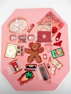 a pink tray filled with lots of assorted items