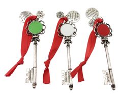 three keys with red ribbon tied around them and two are shaped like key pendants