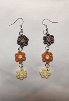 Brown, gold, and cream flower drop earrings. Hooks are made with silver. Handmade Cream Flower Earrings For Gift, Dangle Earrings With 3d Flowers, Brown Flower Earrings With Ear Wire, Beige Flower Earrings As Gift, Handmade Beige Flower Earrings As Gift, Beige Flower Earrings For Gift, Brown Dangle Flower Earrings For Pierced Ears, Handmade Beige Flower Earrings For Gift, Handmade Cream Flower Earrings