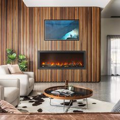 a living room with a couch, coffee table and fire place in front of the fireplace