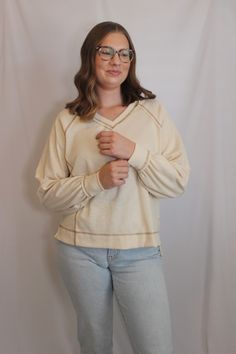 Casual everyday top perfect for the upcoming spring days!

Exposed stitching details make this top unique, yet easy to style. Beige V-neck Sweater With Ribbed Cuffs, Cream V-neck Sweater With Ribbed Cuffs, Cream Soft Knit V-neck Sweater, Cream Oversized V-neck Sweater, Cream V-neck Soft Knit Top, Beige Casual V-neck Sweater For Loungewear, Cream Cotton V-neck Sweater, Casual Cream V-neck Soft Knit Sweater, Casual Cream Soft Knit V-neck Sweater