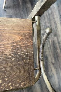 an old wooden chair with metal handles