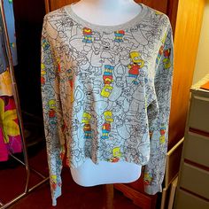 The Simpsons Xl Cropped Long Sleeve T-Shirt New Without Tags. Gray, Orange, Blue & Yellow. 100% Cotton Ptp: 21.5” Length: 19.5” Fun Yellow Tops For Fall, Fun Yellow Fall Tops, Fun Fall Loungewear Tops, Casual Tops With Cartoon Print For Loungewear, Yellow Cotton Tops With Cartoon Print, Fall Cartoon Print Tops For Loungewear, Yellow Crew Neck Top For Fall, Yellow Casual T-shirt For Loungewear, Yellow Long Sleeve Top With Graphic Print