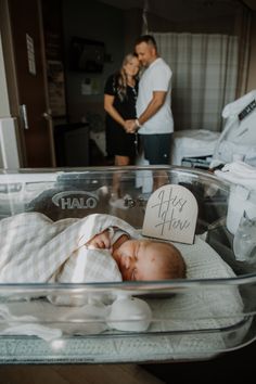 a baby is laying in a glass container