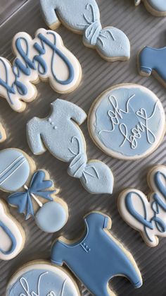 blue and white baby shower cookies are on a baking sheet with the words, it's a boy