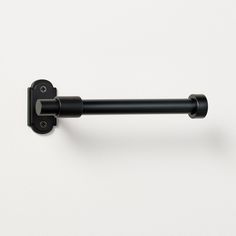 a black handle on a white wall