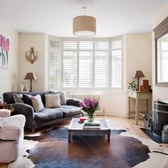 a living room with two couches and a coffee table in front of a fireplace