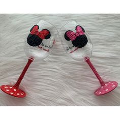 two wine glasses with minnie mouse designs on them