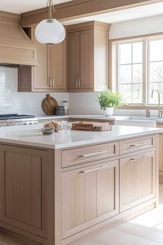 a large kitchen with wooden cabinets and white counter tops, along with a center island