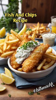 fish and chips recipe with lemon wedges, sour cream sauce and parsley on the side