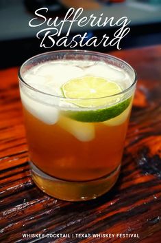 a close up of a drink in a glass on a table with text overlay