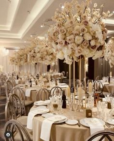 the tables are set with white flowers and place settings