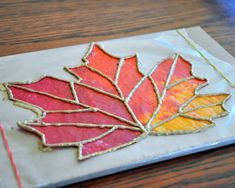 a leaf shaped cookie sitting on top of a piece of paper