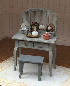 a dollhouse desk with a small bench and clock on it's top shelf