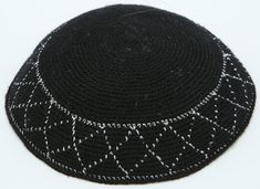 A truly classic solid black body with a beautiful clean design bordering the edge of the Yarmulke makes it loved by adults as well as youngsters. This hand knitted Kippah features silver diagonal stripes on bottom edge. Handmade with 100% cotton and rich high-quality yarns with finer stitching and tight weaving makes its comfortable and long-lasting. Its unique design is appropriate for any Jewish event/occasion including Wedding Party, Bar / Bat Mitzvah or any other family function. Note: Fast Classic Black Knitted Hat, Black Fitted Crochet Hat, Fitted Black Crochet Hat, Fitted Crochet Black Hat, Party Bar, Diagonal Stripes, Black Body, Bar Mitzvah, Bat Mitzvah