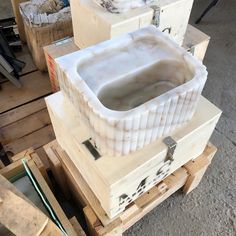 several wooden boxes stacked on top of each other in a room with wood pallets