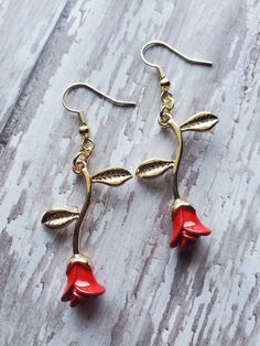 Everlasting roses! Beautiful roses symbolizing love like no other. These gorgeous dainty roses are created of gold plated precious metals with vivid enamel red roses. The earrings dangle at 2.25 inches (half of an inch in width) and are extremely light weight. The earrings have super intricate detailing for a once of a kind realistic look. The earrings are great for any occasion, and if the love for roses are endless then these are the perfect statement!  Purchases will be shipped within 3-5 bus Pink Rose Design Flower Earrings For Valentine's Day, Rose Gold Flower-shaped Earrings For Valentine's Day, Pink Rose Design Earrings For Valentine's Day, Red Flower-shaped Jewelry For Valentine's Day, Red Flower Shaped Jewelry For Valentine's Day, Valentine's Day Red Flower Shaped Jewelry, Rose Earrings For Valentine's Day, Valentine's Day Rose Gold Flower Earrings, Rose Flower Earrings For Gift