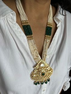 All our pieces are in stock and will be dispatched within 24 to 48 hours of order. Orders received during the weekend will be dispatched on Monday The white and green beads strings on both sides of an elegant Kundan pendant make it a statement wedding necklace. One of our favorite picks for the wedding season 2022❤️ The drop length of the necklace: is approximately 11 inches, and comes with an adjustable string. Length of Earrings: 2 inches Ornate White Jewelry For Festive Occasions, Ornate White Jewelry For Celebrations, Gold Chandbali Beaded Necklaces For Wedding, Gold Chandbali Beaded Necklace For Wedding, Handmade Green Bridal Necklace For Wedding, Traditional White Jeweled Necklace, Ornate White Jewelry For Festivals, Ornate White Ceremonial Jewelry, White Kundan Jewelry For Jewelry Making