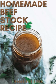 a jar filled with liquid sitting on top of a table next to green leaves and the words homemade beef stock recipe