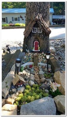 a fairy house built in the rocks under a tree